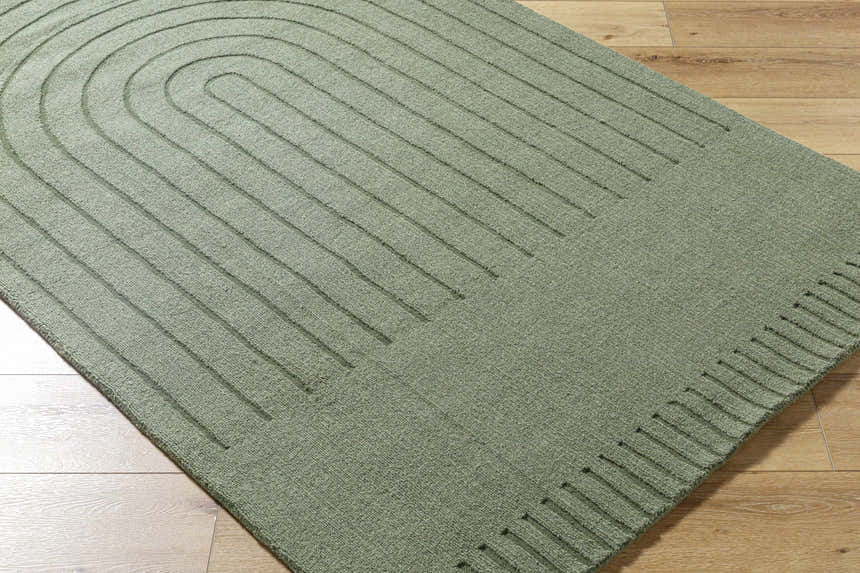 Close up of the Arnona Green Area Rug showing its wool texture and contemporary arch pattern. Corner