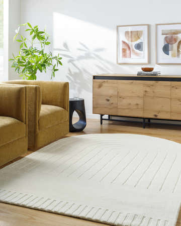Living room scene with mustard chairs and an Arnona Off White area rug with a subtle geometric pattern. Roomscene-Custom