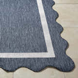 Close-up of the Varro Navy Area Rug showing texture, cream border, and unique scalloped edge. Front