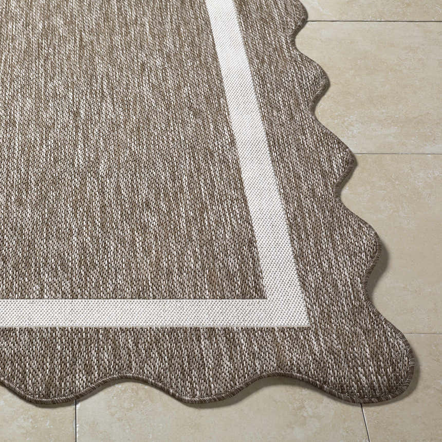 Close-up of the Varro Dark Brown Area Rug showing its woven texture, cream border, and unique scalloped edge. Front