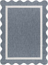 Close-up of the Varro Blue Area Rug showing its blue color, cream border, and scalloped edge. Design-Rectangle-537