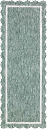 Close up of Varro Medium Green Area Rug showing texture, cream trim, and scalloped edge. Design-Runner-2773