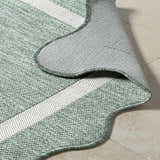 Close-up of the woven texture and cream stripes of the Varro Medium Green Area Rug. Fold