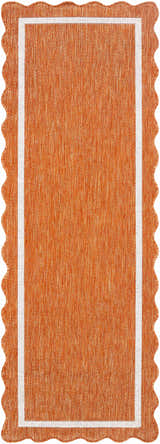 Close-up of the Varro Rust Area Rug. Features a cream border and a unique wavy edge. The rug is rust-colored. Design-Runner-2773