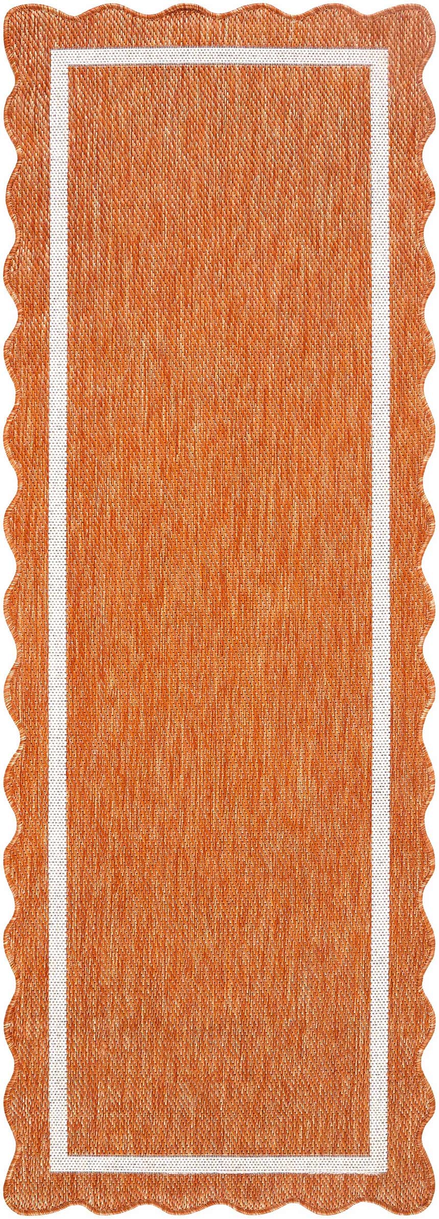 Close-up of the Varro Rust Area Rug. Features a cream border and a unique wavy edge. The rug is rust-colored. Design-Runner-2773