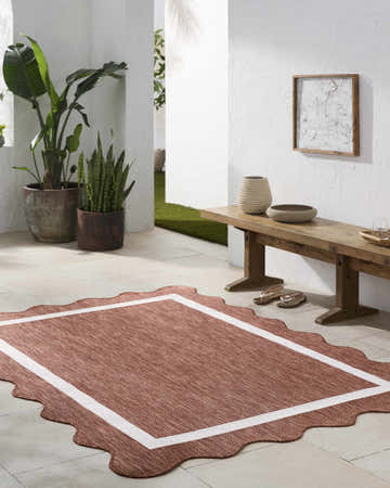 Styled patio with a Varro Cream Area Rug, rustic wood bench, and potted plants. Roomscene-Rectangle