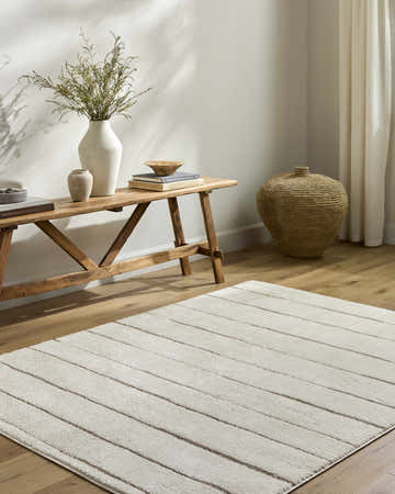 Entryway with a Cascade Cream Area Rug, wooden bench, vases, and a woven basket for a farmhouse feel. Roomscene-Rectangle