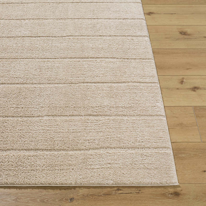 Close-up of the Cascade Brown Area Rug showing its light brown, textured, horizontal striped design on wood floor. Front