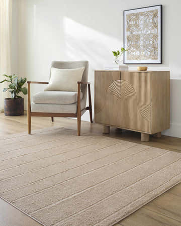 Living room scene with a Cascade Brown Area Rug, gray chair, and light wood cabinet. Roomscene-Rectangle