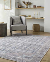 Living room scene with gray chair and Valar Washable Area Rug in beige, blue, and dark red traditional pattern. Roomscene-Rectangle