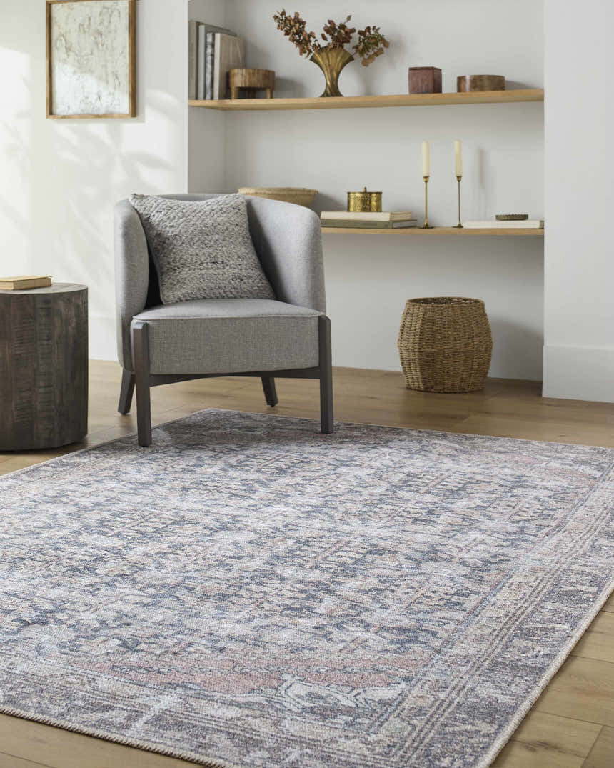Living room scene with gray chair and Valar Washable Area Rug in beige, blue, and dark red traditional pattern. Roomscene-Rectangle