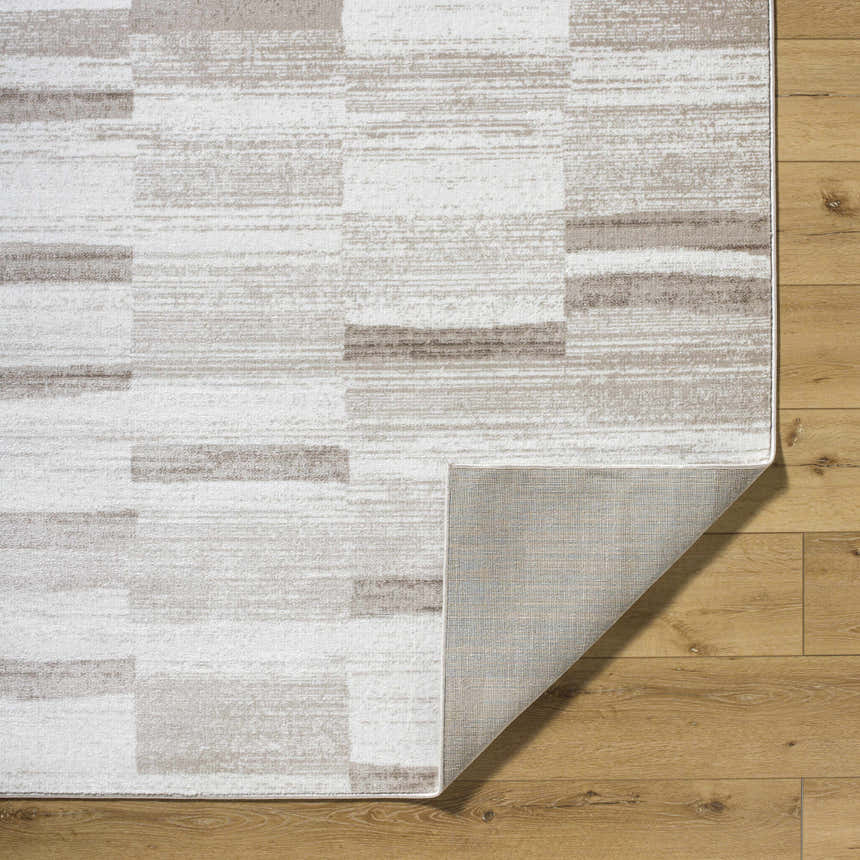 Close up of the Vasso Beige Area Rug showing a contemporary geometric pattern in silver, gray, and beige tones. Fold