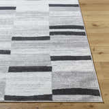 Close-up of the Vasso Gray Area Rug showing its ink, silver gray, and light silver contemporary block pattern. Front
