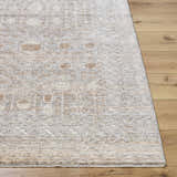 Close-up of Vince Area Rug showing cream, gray, and tan farmhouse design on wood floor. Machine woven polyester rug. Front