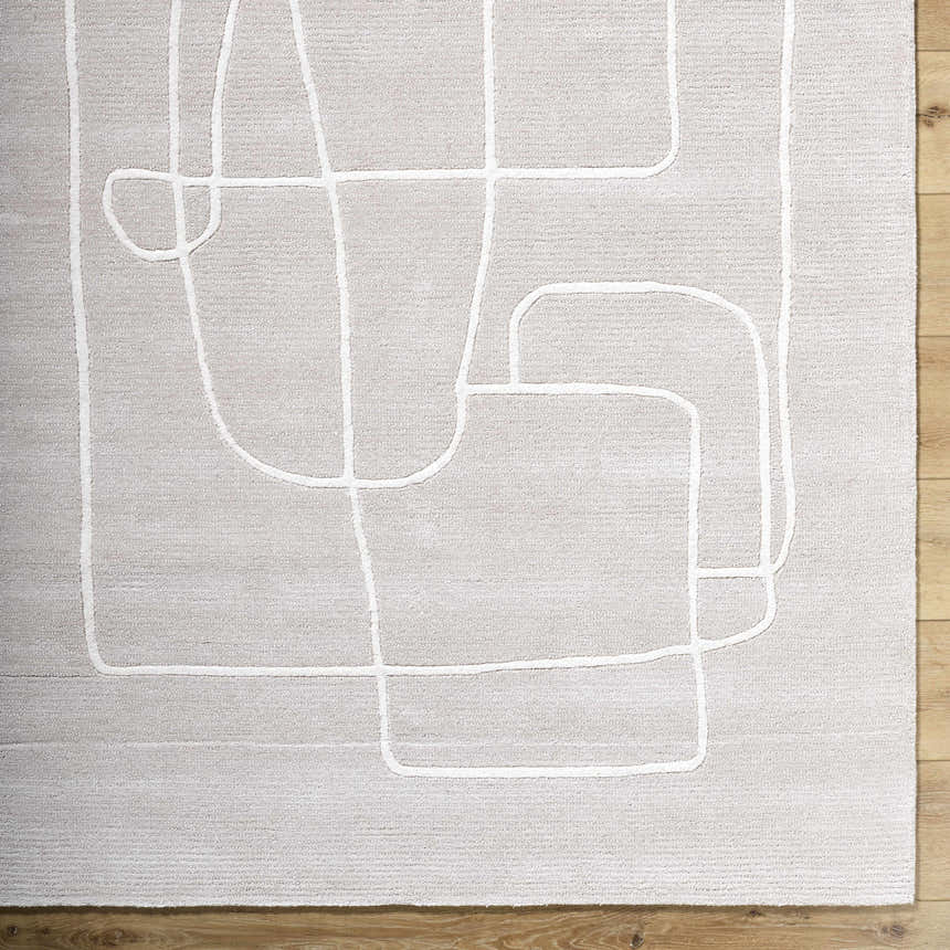 Close-up of the Vatsa Gray Abstract Area Rug. Light silver wool rug with a raised, geometric white line pattern. Swatch