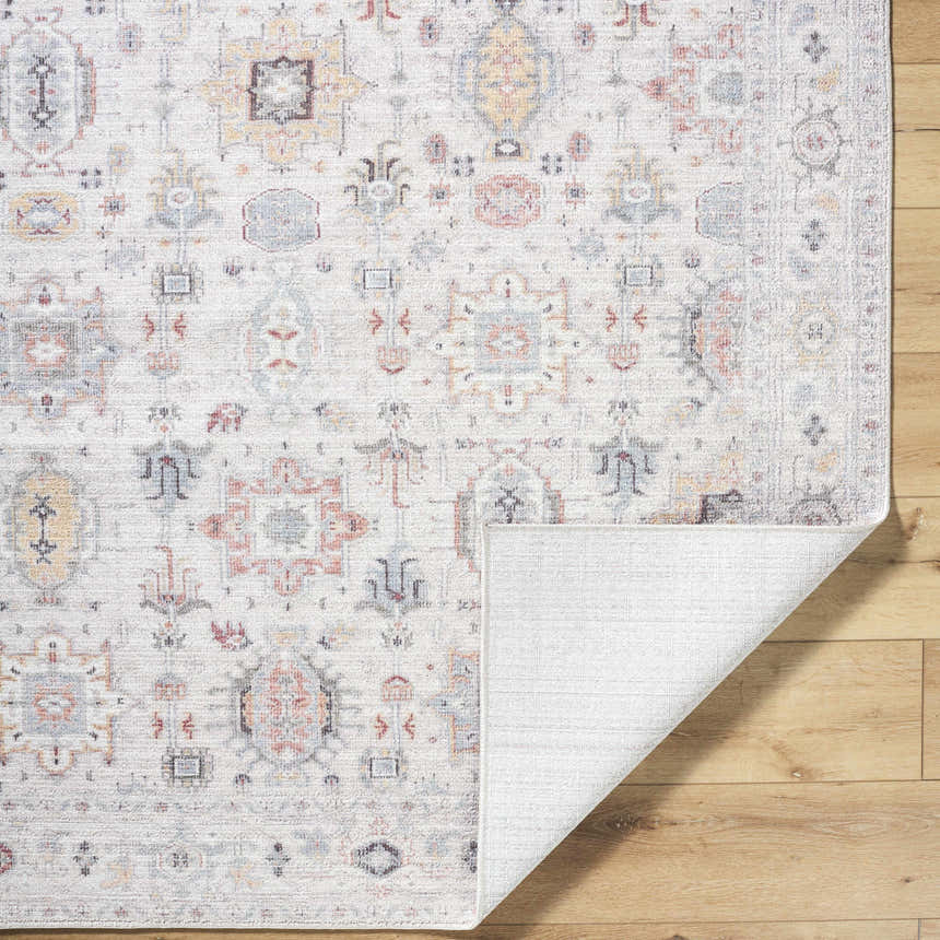 Close-up of the Verna Area Rug showcasing its traditional pattern in dark brown, dusty coral, gray, ivory, peach, and sage colors. Fold