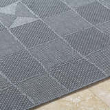Close-up of the Veras Charcoal Area Rug showing its gray woven texture and contemporary geometric pattern. Texture