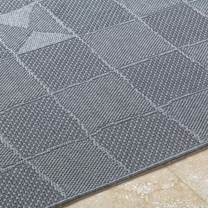 Close-up of the Veras Charcoal Area Rug showing its gray woven texture and contemporary geometric pattern. Texture