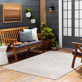 Cozy porch scene with Webuye 3D Outdoor Area Rug in dark gray and peach, wood bench, and potted plants. Roomscene-Rectangle