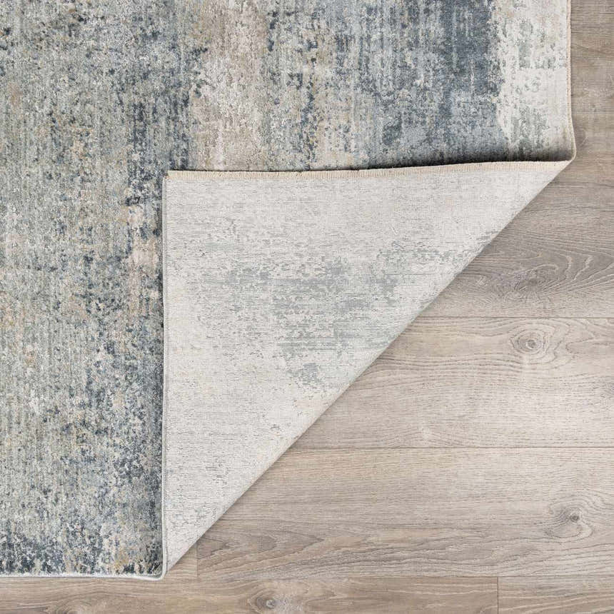 Close-up of the Whyalla Misty Thick Luxe Rug showing its abstract design, dusty sage, light gray, and navy colors. Fold