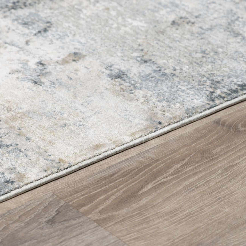 Close-up of the Whyalla Misty Thick Luxe Rug showing its light gray, navy, and taupe abstract pattern and soft texture. Corner