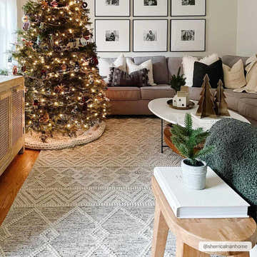 Living room with Christmas tree and gray Whittington Wool Area Rug. Gray sofa, white pillows, and gallery wall. Roomscene-Rectangle