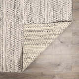 Close-up of the black and cream striped Williford Wool Area Rug showing texture and hand woven construction. Fold