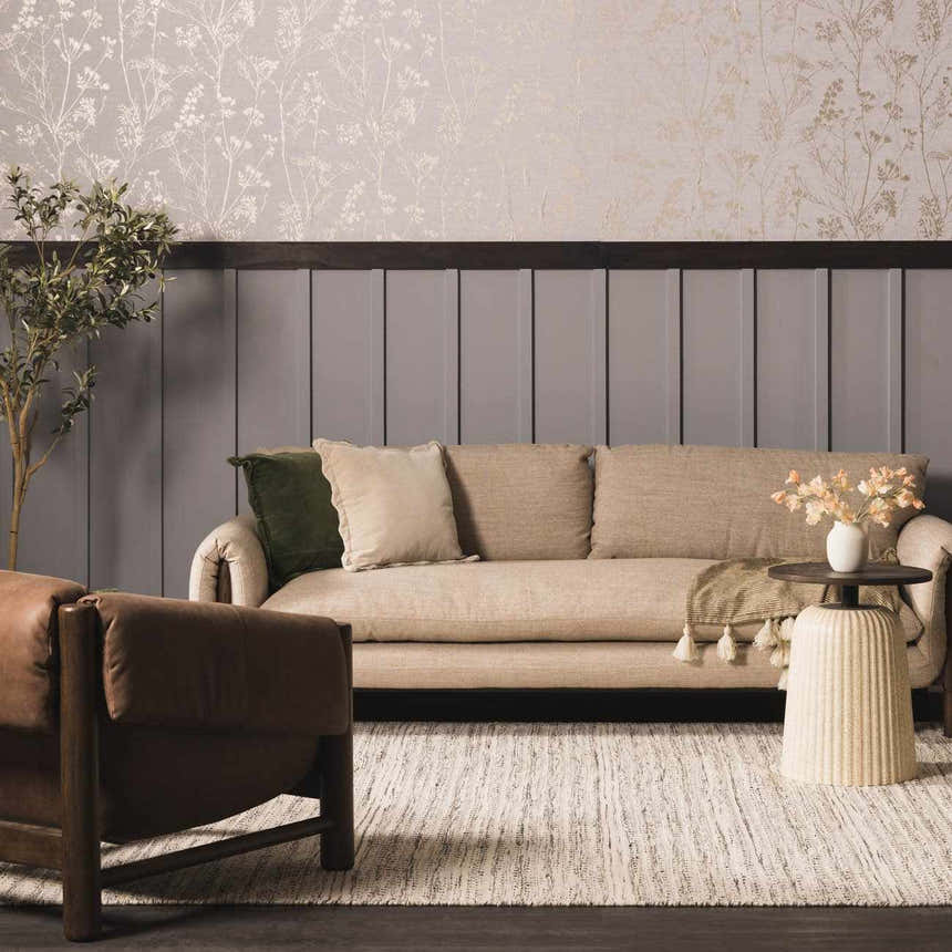 Living room scene with a cream sofa on a black and cream striped Williford Wool Area Rug. Brown leather chair and floral wallpaper. Roomscene-Rectangle