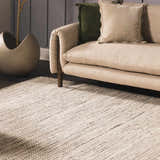 Living room scene with a cream couch and the cream and black Williford Wool Area Rug. Styleshot