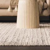 Close-up of the hand woven Williford Wool Area Rug in black and cream, showcasing its texture and striped design. Styleshot