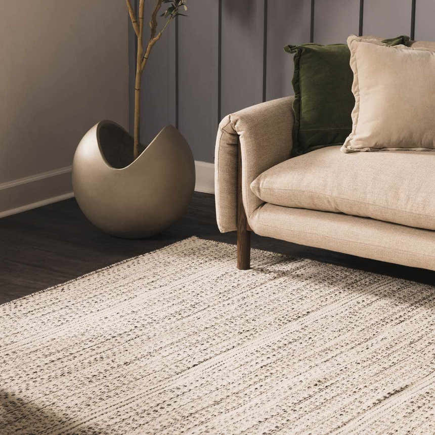 Living room scene with a cream sofa and the cream and black Williford Wool Area Rug. Roomscene-Rectangle