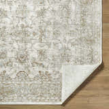 Close-up of the Arella Area Rug showing its ivory, sandstone, and slate gray traditional floral pattern and texture. Fold
