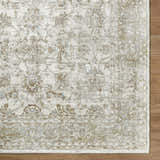 Close-up of the Arella Area Rug in ivory, sandstone, slate gray, and taupe with a traditional floral pattern. Corner