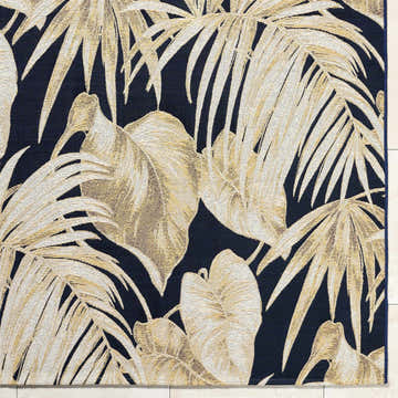 Close-up of the Amirah Midnight Blue Area Rug featuring a goldenrod palm leaf design on a navy background. Swatch