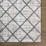 Close up of the Anuhea Off White area rug showing geometric diamond pattern and plush texture. Corner