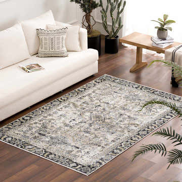 Living room scene with a Holi-4606 Washable Area Rug. Farmhouse style with white sofa, wood floors, and black and gold rug. Roomscene-Rectangle