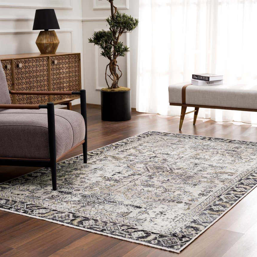 Living room with traditional Holi-4606 Washable Area Rug in black and gold, wood floors, gray chair, and neutral bench. Roomscene-Rectangle