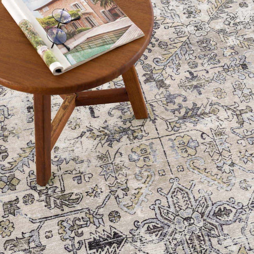 Close-up of the Holi-4606 Washable Area Rug showing its black and gold traditional vintage design and soft texture. Styleshot