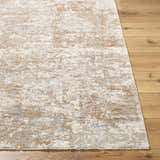 Close-up of the Yakov Area Rug. Contemporary design in cream, tan, blue, and gray on a wood floor. Front