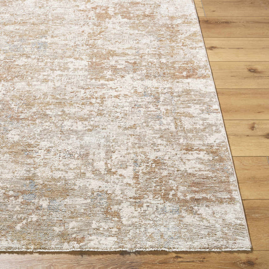Close-up of the Yakov Area Rug. Contemporary design in cream, tan, blue, and gray on a wood floor. Front