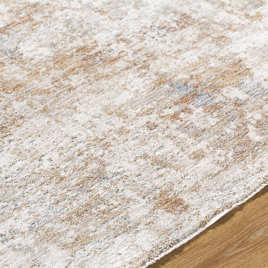 Close up of Yakov Area Rug showing cream, tan, and blue abstract pattern and soft texture. Texture