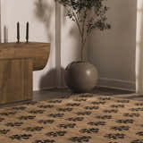 Minimalist room scene with a jute Albina Florentine rug, wood console table, candles, and potted tree. Roomscene-Rectangle