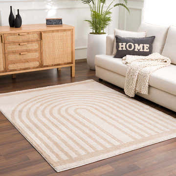 Living room scene with a beige Yasuo Washable Area Rug, cream sofa, wood cabinet, and houseplant for a contemporary look. Roomscene-Rectangle
