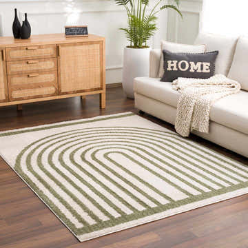 Living room scene with a Yasuo Green Washable Area Rug, white sofa, wood cabinet, and potted plant. Modern, inviting space. Roomscene-Rectangle