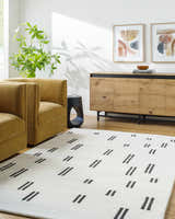 Living room scene with mustard chairs and the Yitta Ivory Area Rug. Roomscene-Rectangle