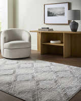 Living room scene with cream swivel chair and light gray Yayoi Area Rug with geometric pattern. Roomscene-Rectangle