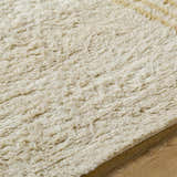 Close-up of the hand-tufted Yahto Area Rug. Camel, desert tan, and pearl wool fibers create a soft, textured farmhouse rug. Texture