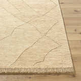 Close-up of the hand-tufted Addien Area Rug. Farmhouse style, 100% wool rug with geometric pattern and textured weave. Front