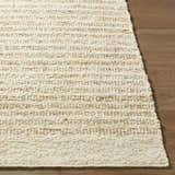 Close up of the hand woven Yaron Area Rug showing pearl and tan stripes on wood floor. Front