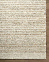 Close-up of the hand woven Yaron Area Rug showing its pearl and tan jute and wool striped texture. Corner